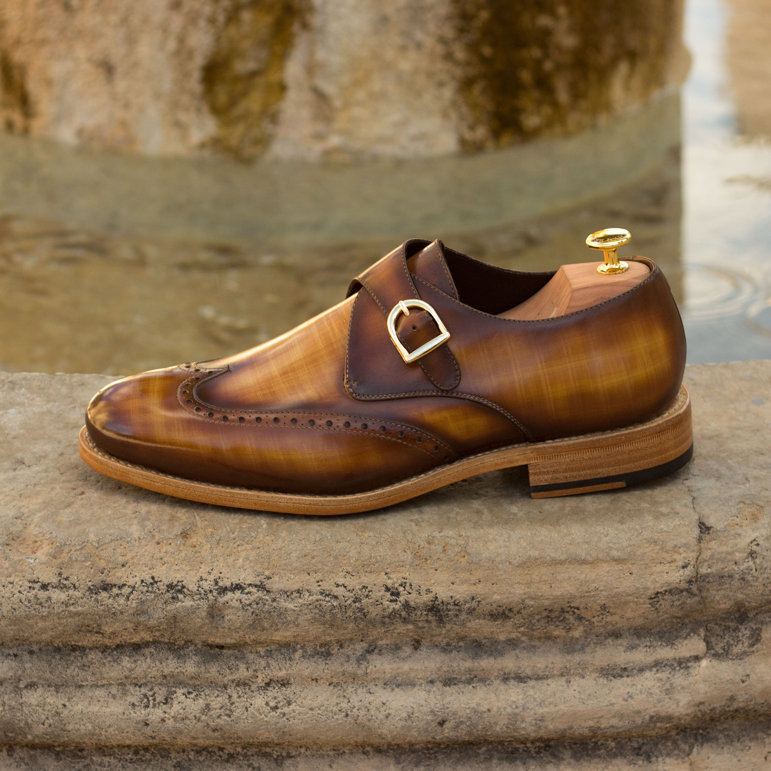 Single monk-strap custom dress shoe with hand-painted patina finish.